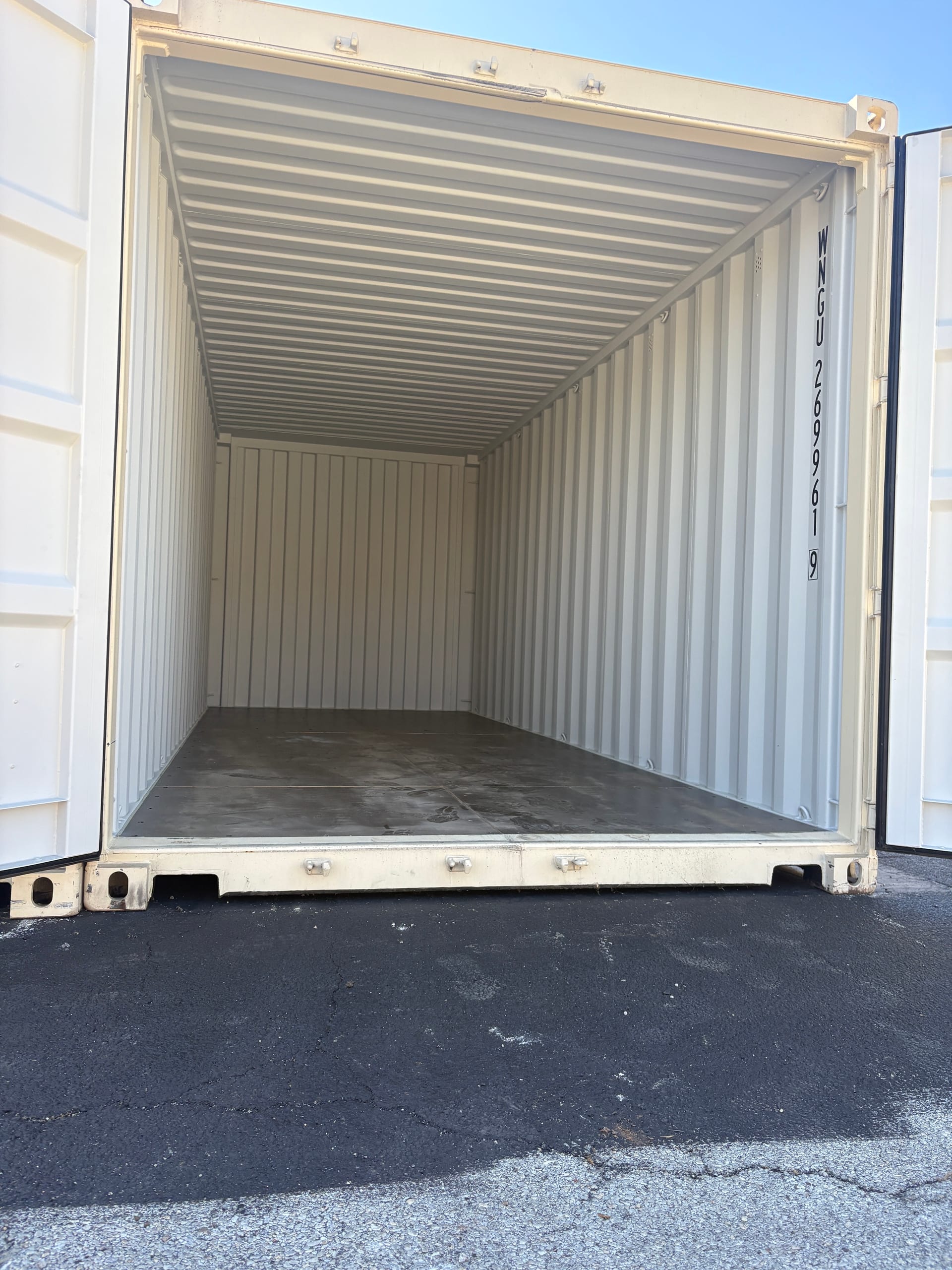 Clean, empty interior of a long 3k Storage unit with its doors open
