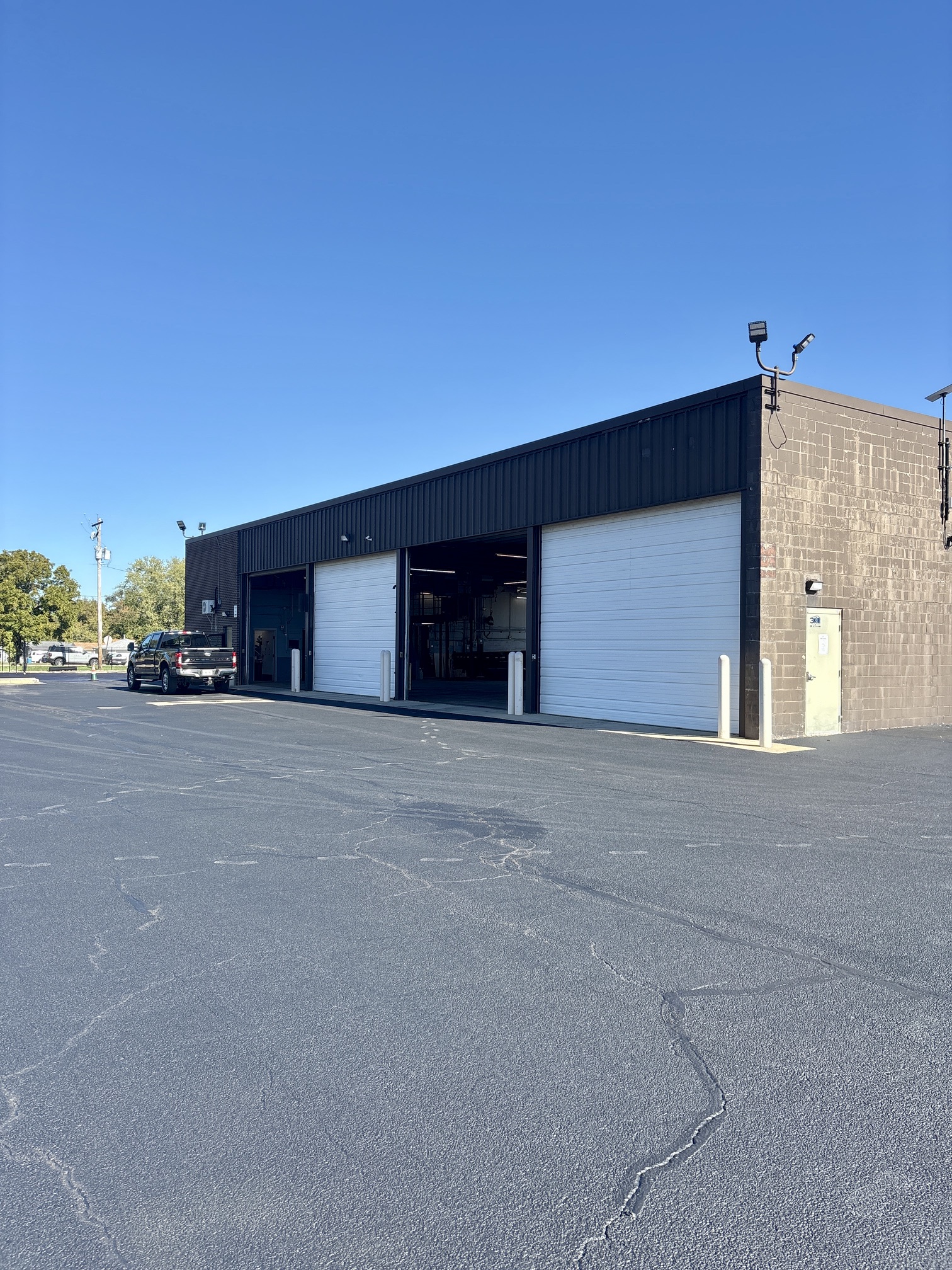 Exterior of the 3k Storage indoor RV and boat storage building with large white overhead doors on a paved lot